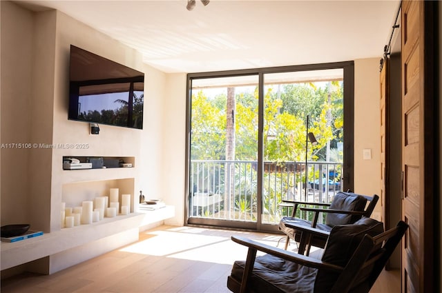 interior space with floor to ceiling windows and hardwood / wood-style flooring