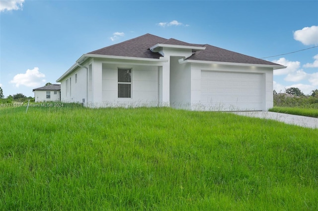 view of side of home featuring a lawn and a garage