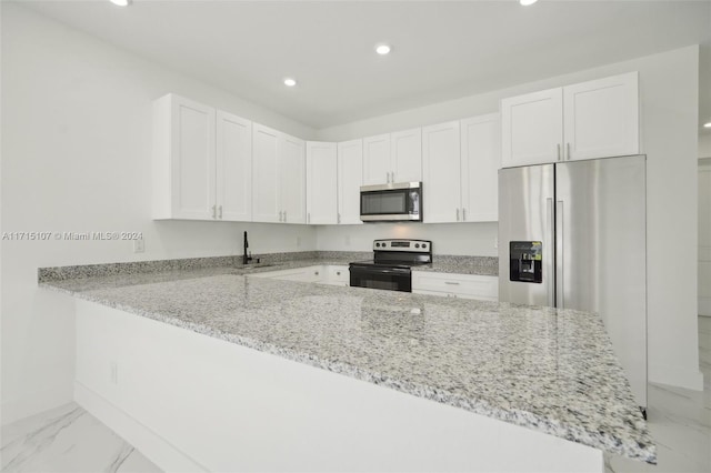 kitchen with kitchen peninsula, white cabinetry, light stone countertops, and appliances with stainless steel finishes