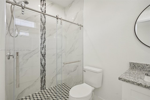 bathroom with vanity, toilet, and an enclosed shower