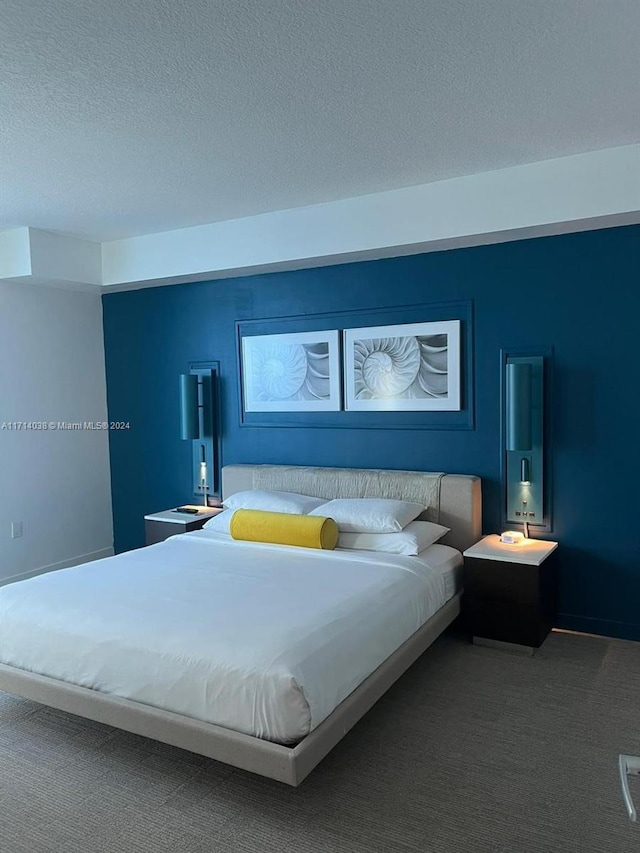 bedroom with a textured ceiling and carpet floors