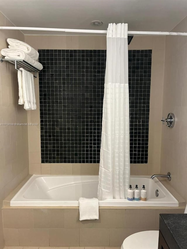 full bathroom with shower / tub combo, vanity, and toilet