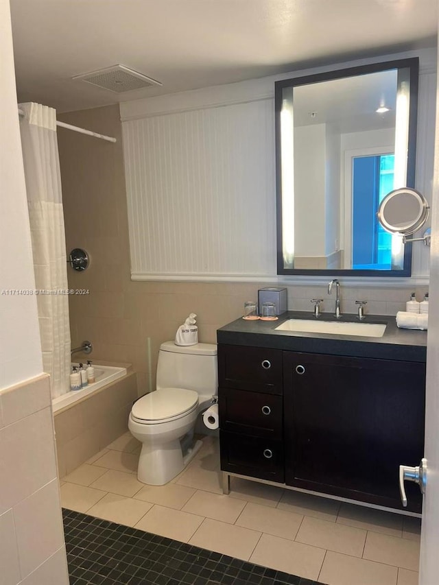 full bathroom with tile patterned floors, vanity, toilet, and shower / bath combo with shower curtain