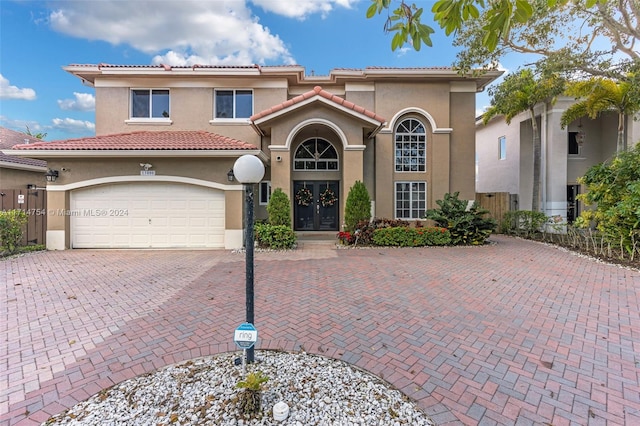 mediterranean / spanish house featuring french doors and a garage