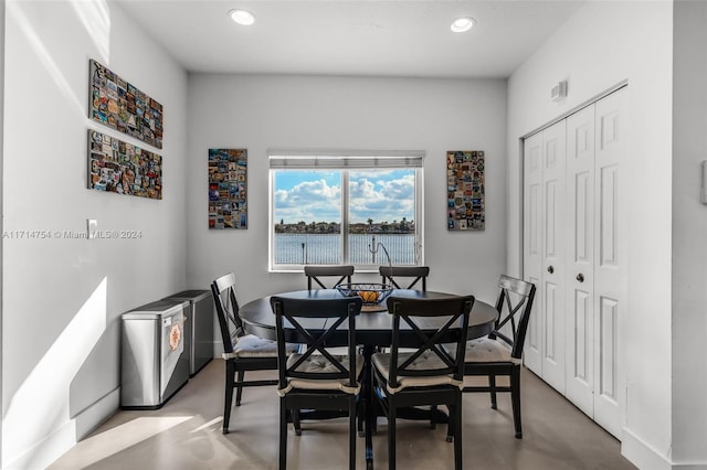 dining space featuring concrete flooring