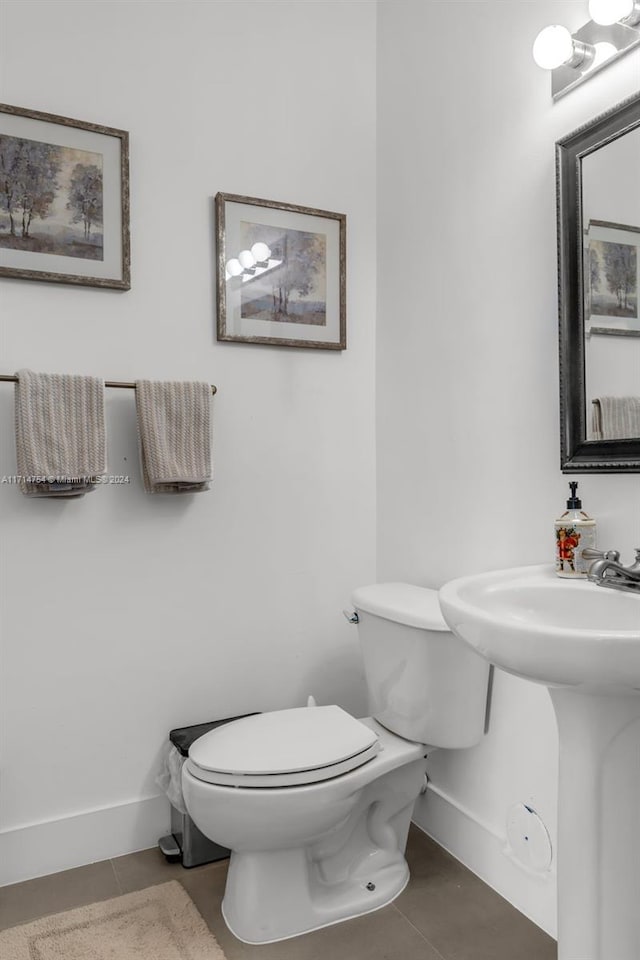 bathroom featuring tile patterned flooring and toilet