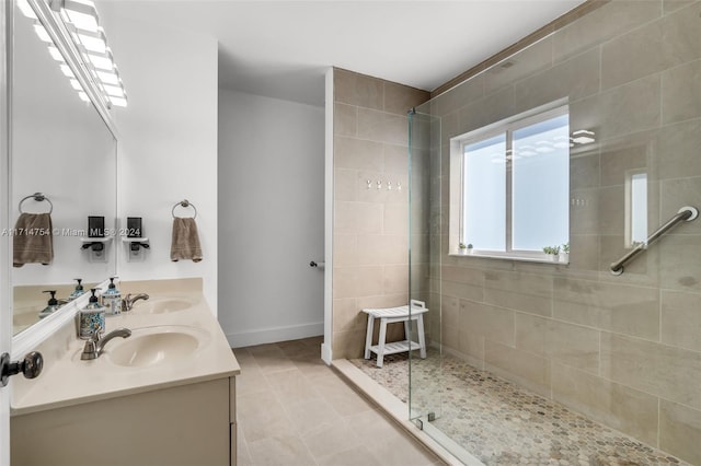 bathroom featuring tile patterned flooring, vanity, and walk in shower