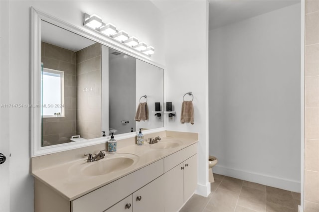 bathroom featuring tile patterned floors, vanity, and toilet