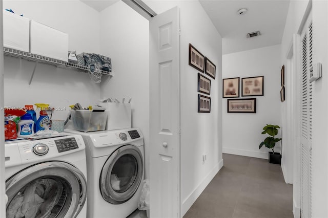 washroom with washing machine and clothes dryer