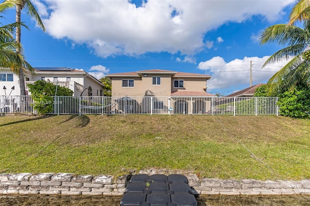 rear view of property with a lawn