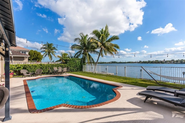 view of pool with a water view and a patio