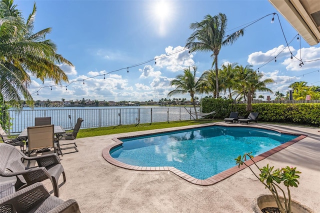 view of pool with a water view and a patio area