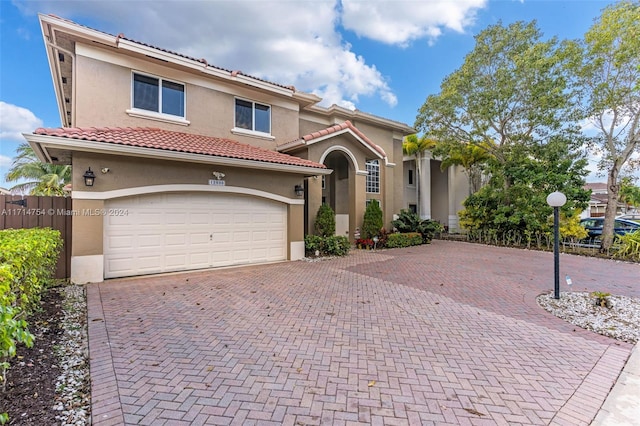 mediterranean / spanish-style home featuring a garage