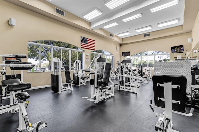 gym with a towering ceiling