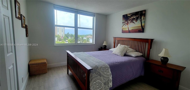 bedroom with multiple windows and a textured ceiling