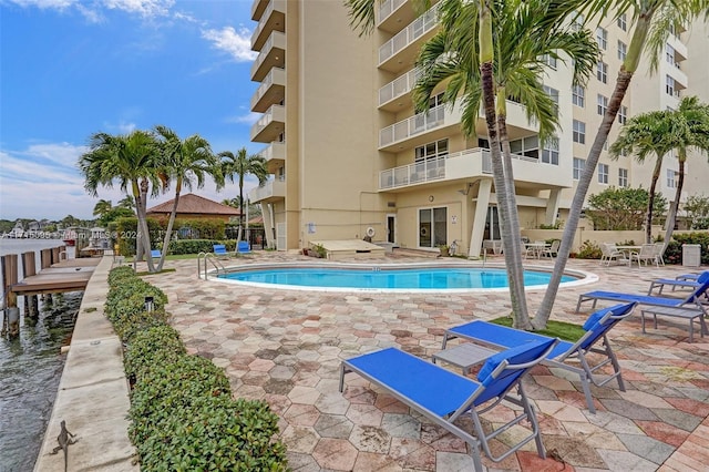 view of swimming pool featuring a patio area