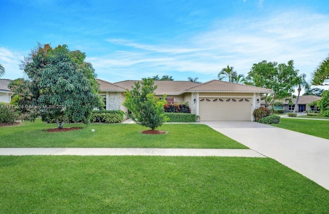 view of front of property with a garage and a front lawn