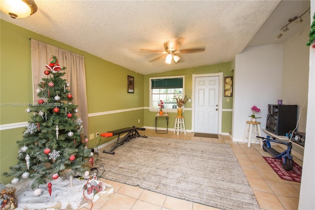 tiled foyer with ceiling fan and a textured ceiling