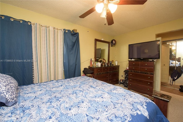 bedroom featuring ceiling fan, a textured ceiling, and a closet