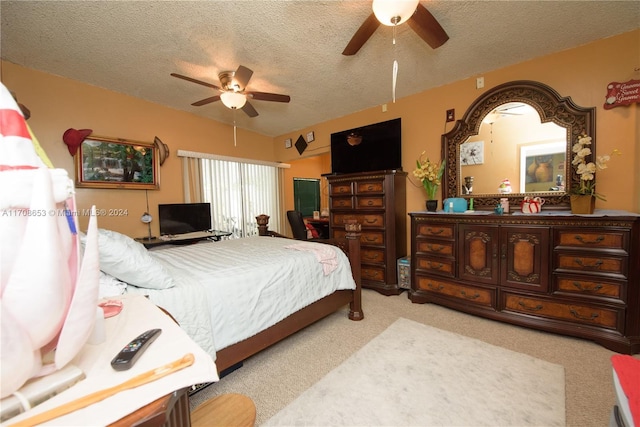 carpeted bedroom with a textured ceiling and ceiling fan