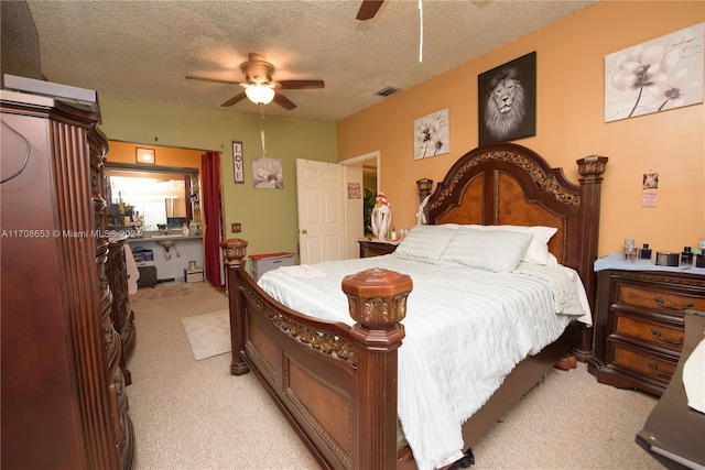 bedroom with ceiling fan, a textured ceiling, and light carpet