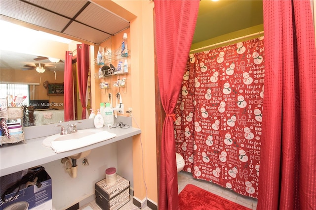 bathroom featuring tile patterned floors, ceiling fan, sink, and toilet