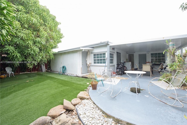 back of house featuring a yard and a patio