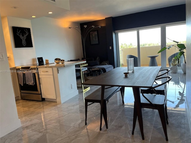 dining space featuring marble finish floor, baseboards, and recessed lighting