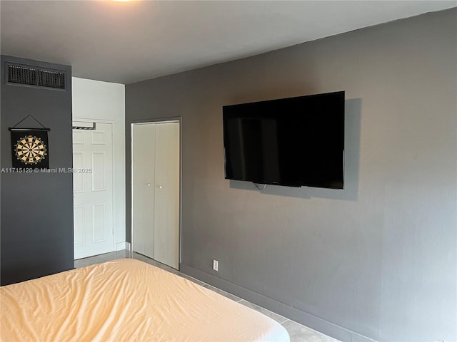 bedroom featuring baseboards and visible vents