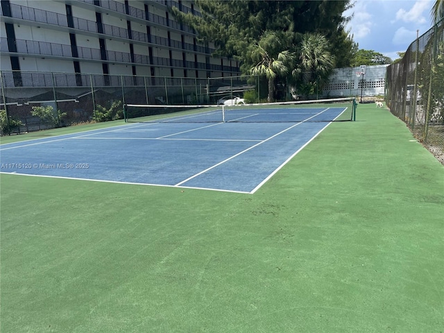 view of sport court featuring fence