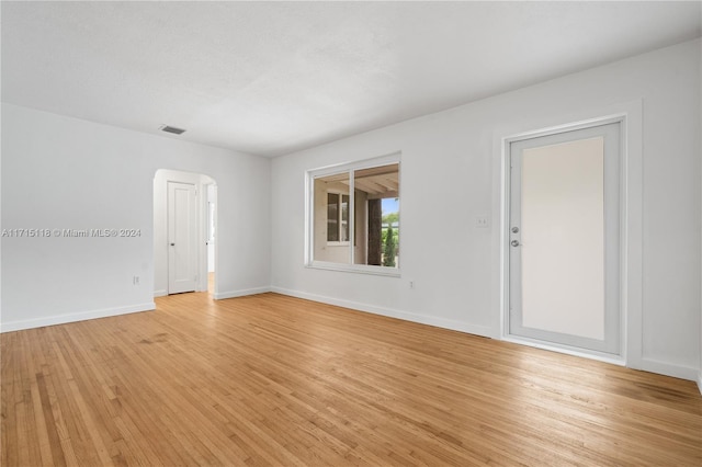 empty room with light hardwood / wood-style flooring