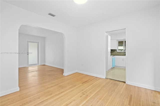 empty room with light hardwood / wood-style flooring