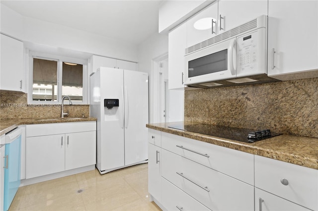 kitchen featuring tasteful backsplash, sink, white cabinets, and white appliances