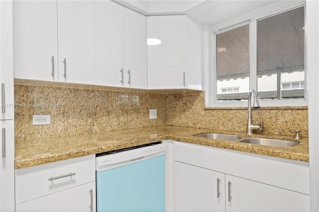 kitchen featuring white cabinets, dishwasher, sink, and tasteful backsplash