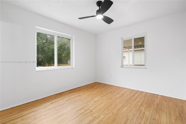 empty room with ceiling fan and light wood-type flooring