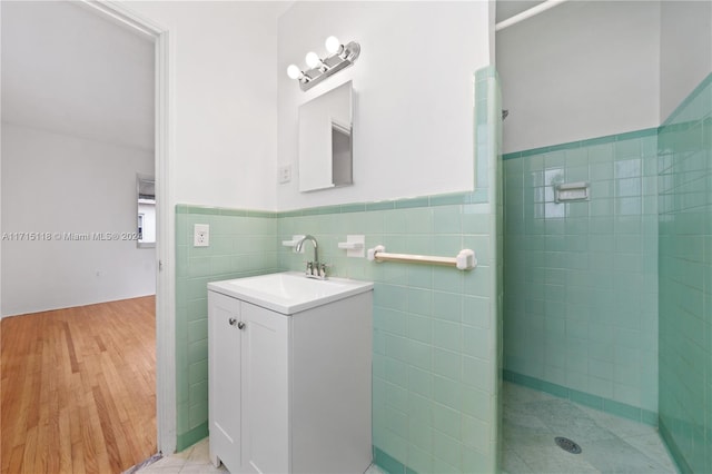 bathroom featuring vanity and tile walls