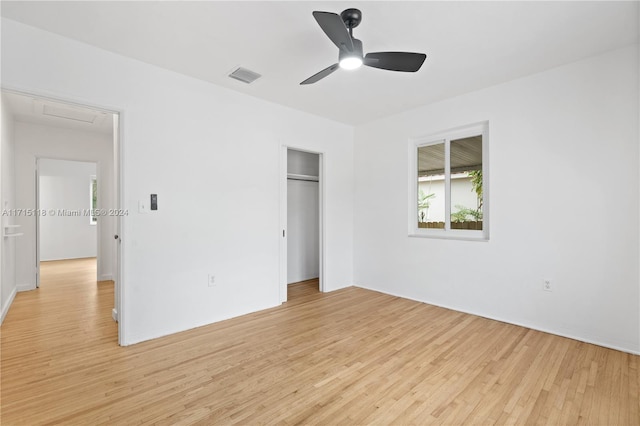 unfurnished bedroom with ceiling fan, a closet, and light hardwood / wood-style flooring