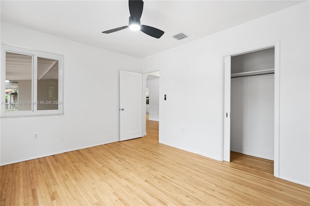 unfurnished bedroom with ceiling fan, a closet, and light hardwood / wood-style flooring