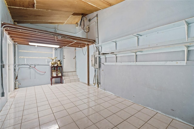 basement with electric panel and light tile patterned floors