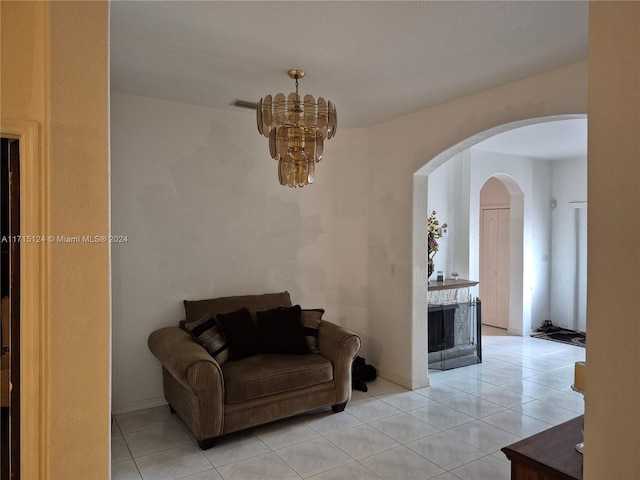 living room featuring light tile patterned floors and an inviting chandelier