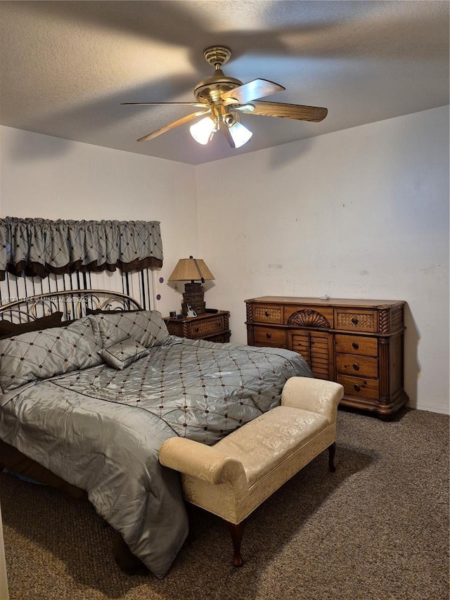 bedroom featuring a textured ceiling, carpet floors, and ceiling fan