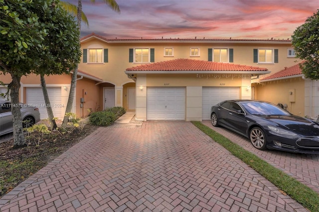 mediterranean / spanish home with a garage