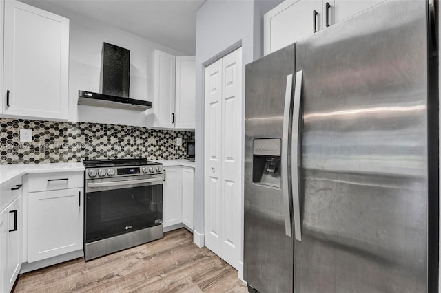 kitchen featuring decorative backsplash, stainless steel appliances, exhaust hood, light hardwood / wood-style flooring, and white cabinets