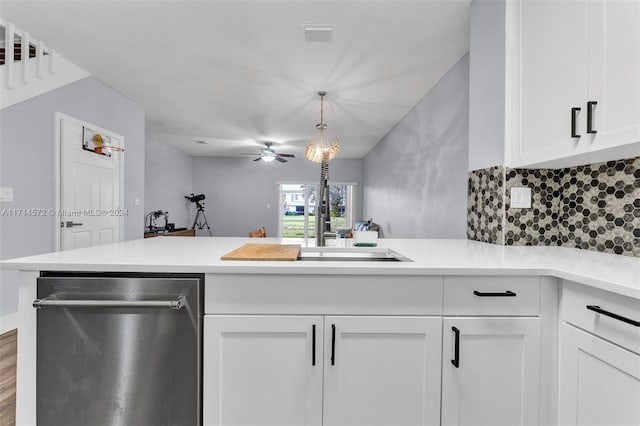 kitchen with white cabinetry, dishwasher, ceiling fan, kitchen peninsula, and pendant lighting