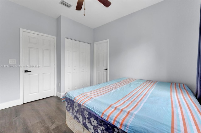 bedroom with a closet, ceiling fan, and dark wood-type flooring