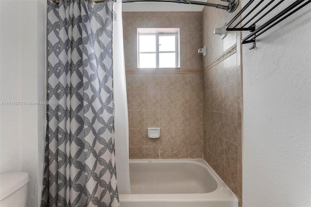 bathroom with toilet and shower / tub combo with curtain