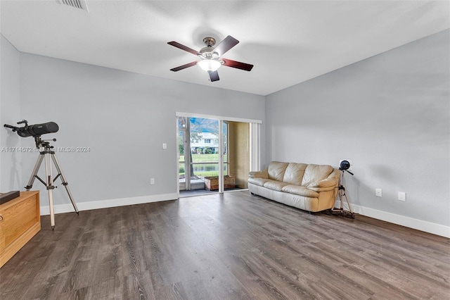 unfurnished living room featuring ceiling fan and dark hardwood / wood-style floors