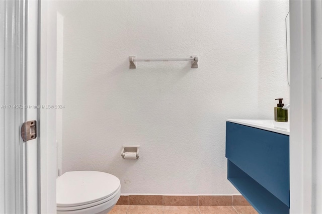 bathroom with tile patterned floors, vanity, and toilet