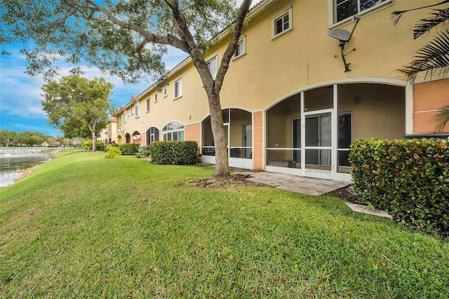 rear view of property with a yard