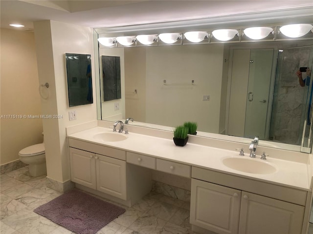 bathroom featuring vanity, toilet, and an enclosed shower